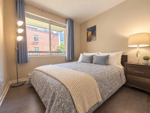 Second queen bedroom with large window — Bright 2BR Retreat