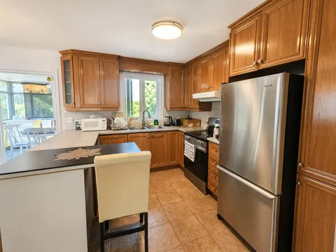 Full kitchen — Spacious 3BR Home with Private Backyard