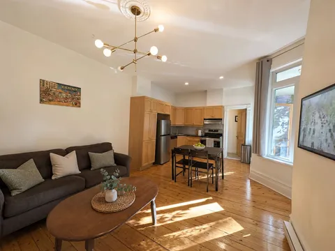 Heritage living room with warm wood floors and natural light — Cozy Heritage 2BR with Lush Private Garden Patio