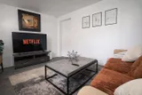 Living room with sofa and television — Rehoboth 1BR in Laval