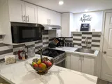 Kitchen with stove and refrigerator — Stylish Modern 1BR with EV Charger