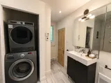 In-unit laundry area with washer and dryer — Cozy Heritage 2BR with Lush Private Garden Patio