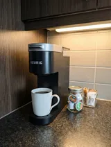 Coffee maker and drink supplies — Modern 1BR with Private Bath