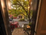 Balcony overlooking the street — Luxury 2BR in the Plateau