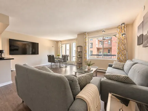 Bright open-concept living room with large windows — Bright 2BR Retreat
