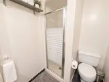 Enclosed shower in the second bathroom — Bright 2BR Retreat