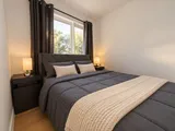 Second queen bedroom with upholstered headboard — Modern 3BR Spacious Home
