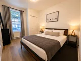 Bedroom with window and bedside tables — Cozy Luxury in the Plateau