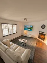 Living room with sofa and television — Modern 1BR with Private Bath