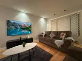 Living room with sofa and television — Stylish Getaway 3BR with Heated Pool