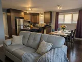 Living area opening onto the kitchen — Modern 1BR with Desk Near YUL