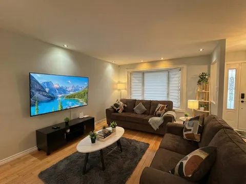 Living room with sofa and television — Stylish Getaway 3BR with Heated Pool