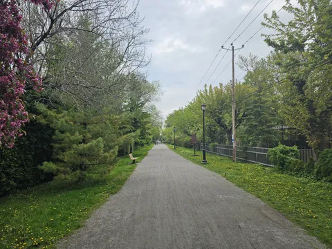 Tree-lined urban path in Longueuil’s parc linéaire Desaulniers