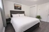 Bedroom with bed and bedside lighting — Rehoboth 1BR in Laval