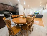 Kitchen and dining table — Spacious 2BR Holiday Home Near YUL