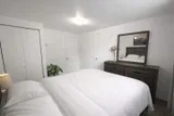 Bedroom with dresser and wardrobe — Rehoboth 1BR in Laval