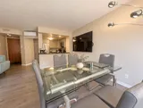 Dining table and open kitchen — Bright 2BR Retreat