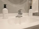 Bathroom sink and toiletries — Cozy Studio Near YUL