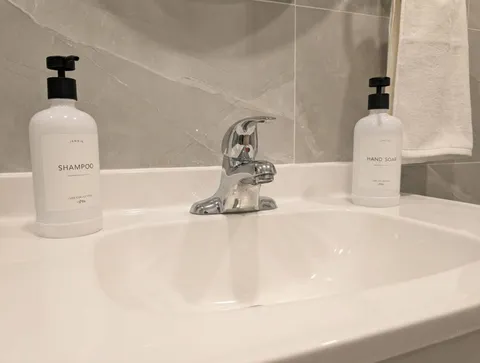 Bathroom sink and toiletries — Cozy Studio Near YUL