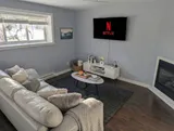 Living room with sofa and television — Modern 1BR with Desk Near YUL