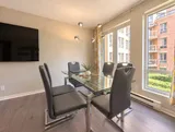 Sunny six-person dining space with courtyard windows — Bright 2BR Retreat