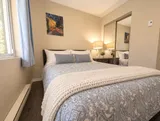 Second bedroom bedside table and storage — Bright 2BR Retreat