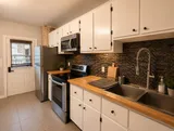 Kitchen with stove and refrigerator — Luxury 2BR in the Plateau