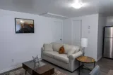 Living room seating and coffee table — Rehoboth 1BR in Laval