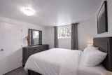 Bedroom with dresser and wardrobe — Rehoboth 1BR in Laval