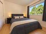 Third queen bedroom with bedside lamps — Modern 3BR Spacious Home