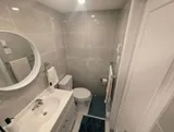 Bathroom sink and toilet — Cozy Studio Near YUL