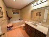 Bathroom with bathtub and vanity — Stylish Getaway 3BR with Heated Pool