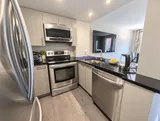 Full kitchen with stainless steel appliances — Bright 2BR Retreat