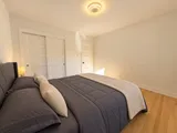 First queen bedroom with closet doors — Modern 3BR Spacious Home
