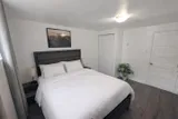 Bedroom with bed and bedside lighting — Rehoboth 1BR in Laval