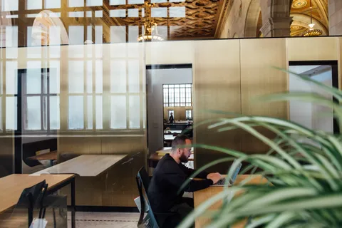 Professional working on a laptop in a bright open workspace in Old Montreal