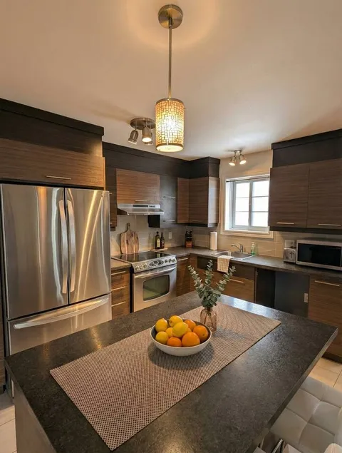 Kitchen island and counter seating — Modern 1BR with Private Bath