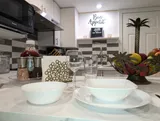 Kitchen place settings and counter — Stylish Modern 1BR with EV Charger