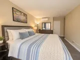 First bedroom bed and bedside table — Bright 2BR Retreat