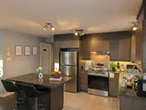 Kitchen with stove and refrigerator — Modern 1BR with Desk Near YUL