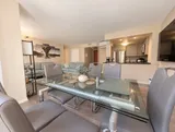 Six-seat dining area beside the living room and kitchen — Bright 2BR Retreat