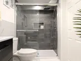 Bathroom with enclosed shower — Stylish Modern 1BR with EV Charger