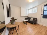 Living room beside the entrance and window — Cozy 2-Bedroom Retreat
