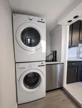 In-unit laundry area — New Luxury 4BR Plateau Stay