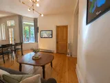 Heritage living space with comfortable sofa seating — Cozy Heritage 2BR with Lush Private Garden Patio