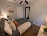 Bedroom with bed and bedside lighting — Luxury 2BR in the Plateau