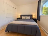 Third queen bedroom with closet doors and window — Modern 3BR Spacious Home