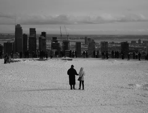 Visitors on a snowy Mount Royal lookout overlooking downtown Montreal
