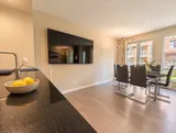Kitchen breakfast bar opening onto the dining room — Bright 2BR Retreat