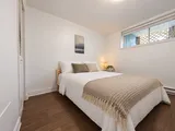 Second queen bedroom with white linens and nature artwork — Cozy 2-Bedroom Retreat